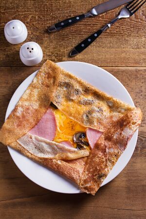 Crepes, thin pancakes with ham, cheese, egg,  and mushrooms. View from above, top studio shotの写真素材