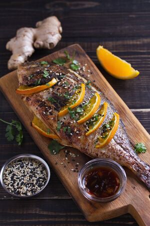 Orange ginger fish, sprinkled with sesame seeds and cilantro. Soy orange sauceの写真素材