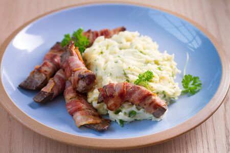 Lamb liver wrapped in bacon with mash potatoの写真素材