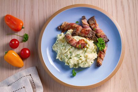 Lamb liver wrapped in bacon with mash potato. View from above, topの写真素材