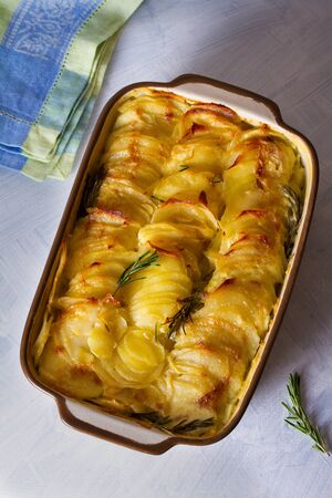 Potato gratin (with cream and butter). Scalloped potatoes or potato bake. View from above, top viewの写真素材