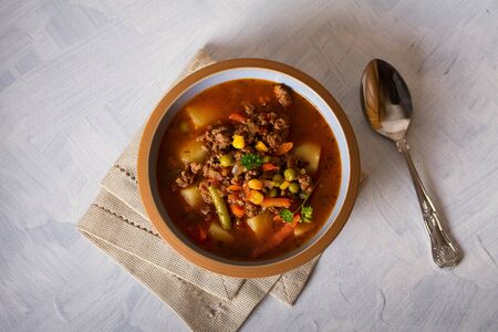 Delicious hamburger soup with vegetables. Healthy nutrition food. View from above, top viewの写真素材