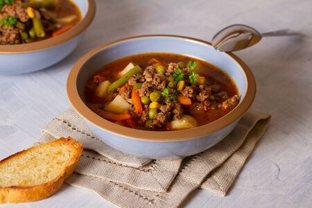 Bowl of ground beef soup with vegetables. Healthy food. horizontal imageの写真素材