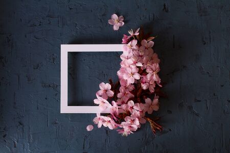 Layout made of spring fruit flowers and white paper card note frame. Mockup, flat lay. Spring flower backgroundの写真素材