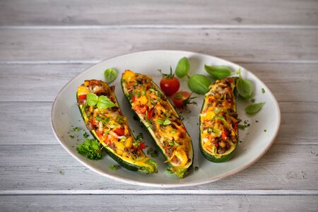 Zucchini stuffed with meat, vegetables and cheese. Zucchini boats. Loaded zucchini. Horizontal imageの写真素材