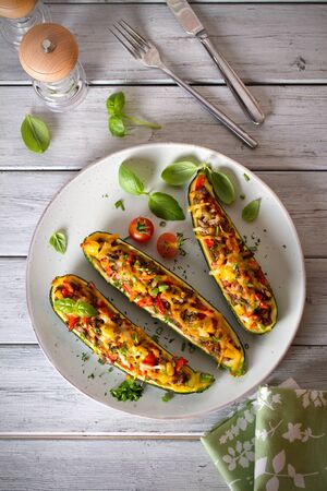 Zucchini stuffed with meat, vegetables and cheese. Zucchini boats. Loaded zucchini. overhead vertical imageの写真素材