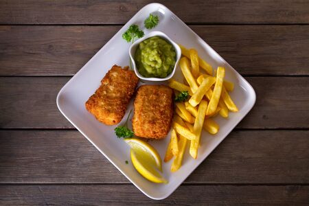 Fish and chips, mushy peas and sauce. Battered fish with french fries. View from above, top viewの写真素材