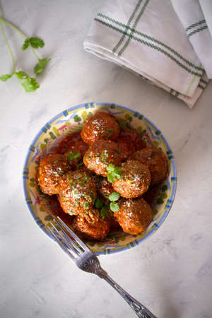Meatballs with tomato sauce and cheese. Overhead vertical photoの写真素材
