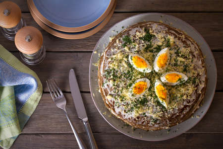Layered liver cake with cheese, mayonnaise and dill. Savory cake. Overhead horizontal photoの写真素材