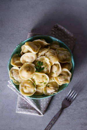 Dumplings, filled with meat. Traditional Russian dish pelmeni. Dumplings with filling. View from...