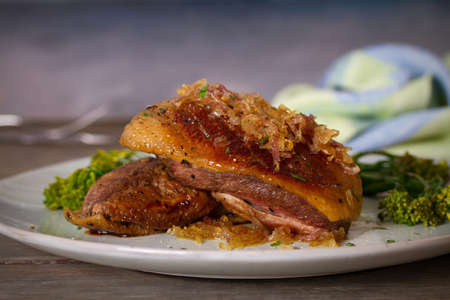 Roast duck breast fillets with vegetables on plate. vertical imageの写真素材