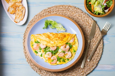 Prawn omelette with peas. Eggs with shrimps. View from above, top studio shotの写真素材