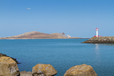 Lighthouse and Ireland's Eye island in Howth, an Irish town on the Howth Peninsula. View of calm blue sea and clear skyの写真素材