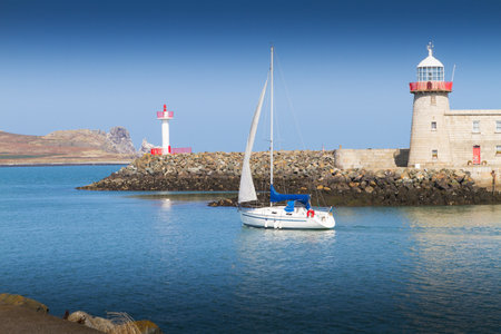Lighthouse in Howth, an Irish town on the Howth Peninsula Dublin Ireland. View of calm blue sea and clear skyの写真素材