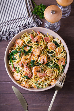 Prawn and bacon pasta with spinach. Spaghetti. View from above, top viewの写真素材