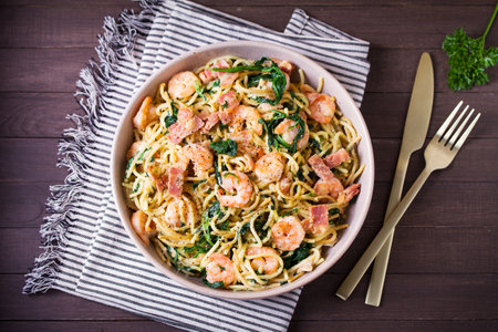 Prawn and bacon pasta with spinach. Spaghetti. View from above, top viewの写真素材