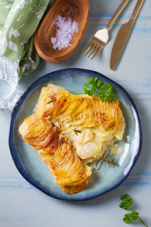 Tender creamy potato gratin with rosemary. Scalloped potatoes or potato bake. High angle viewの写真素材