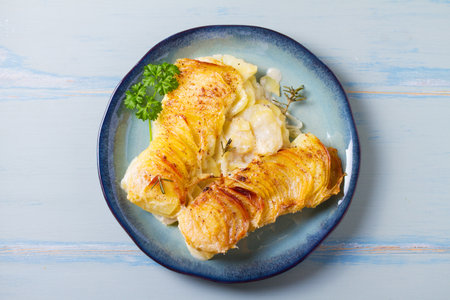 Tender creamy potato gratin with rosemary. Scalloped potatoes or potato bake. High angle viewの写真素材