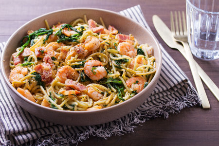 Seafood pasta with spinach and bacon. Spaghetti with shrimpsの写真素材