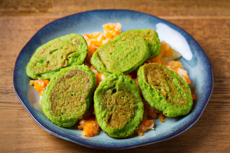 Vegetable fritters, pancakes or cakes on blue plateの写真素材