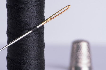 Thread with a needle and thimbleの写真素材