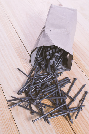 Pack full of nails on wooden tableの写真素材