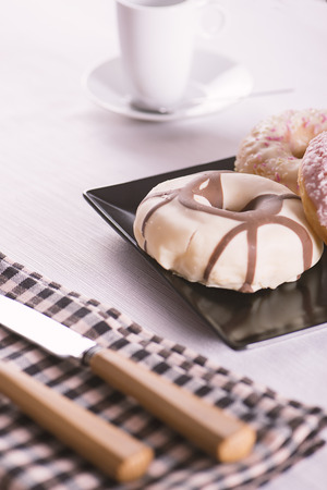 Donuts with various flavors eating utensil and napkinの写真素材