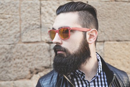 Closeup of a modern young man with red sunglasses. Hipsterの写真素材
