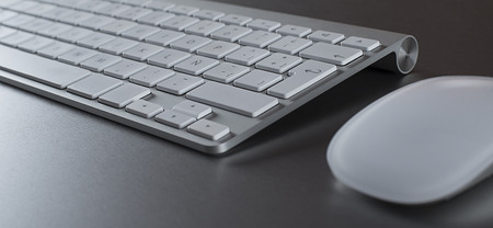 Computer keyboard and mouse on a table.