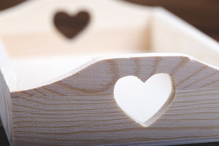 Wooden tray with heart cut instead of handle. Horizontal studio shotの写真素材