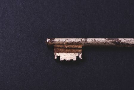 Front of an Old key on black backgroundの写真素材