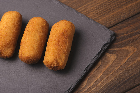 Croquettes on plate of slate seen from above. Horizontal shoot.の写真素材