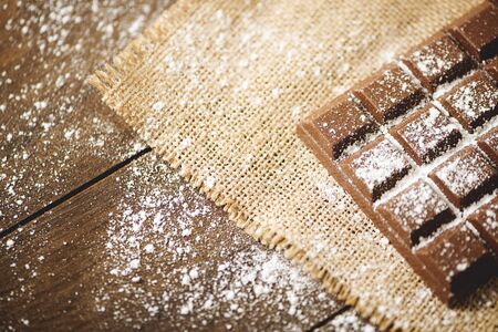Chocolate tablet with icing sugar. Horizontal shoot.の写真素材