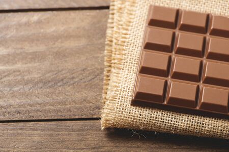 Chocolate tablet on brown fabric. Horizontal shoot.の写真素材