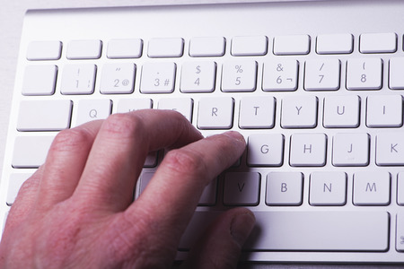 Hand on a computer keyboard while browsing the internet. Technology.