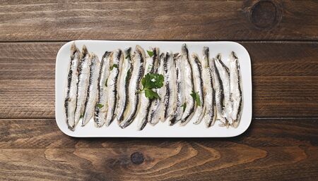 Aerial plane of anchovy dish with olive oil, vinegar and lemon. Horizontal shoot.の写真素材