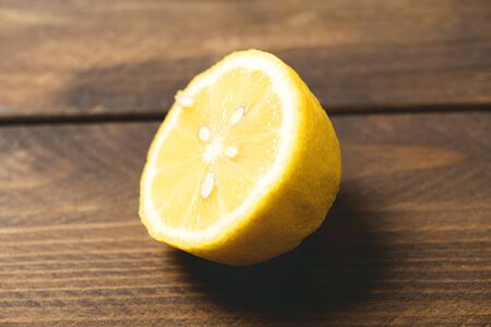 Half lemon on wooden table. Horizontal shoot.の写真素材