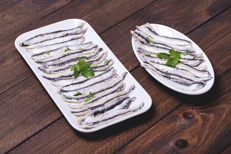 Tasty anchovies on white trays. Horizontal shoot.の写真素材