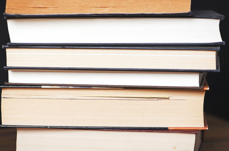 Close-up of used stacked books.