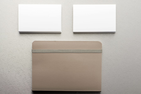Business card and notepad on gray background. Business and education.