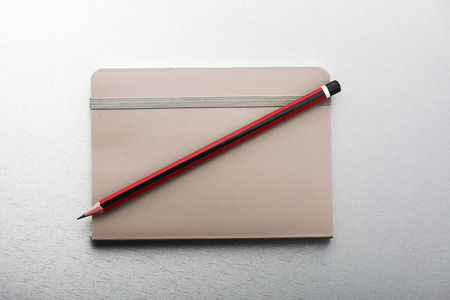 Pencil and notepad on gray background. Horizontal shoot.の写真素材