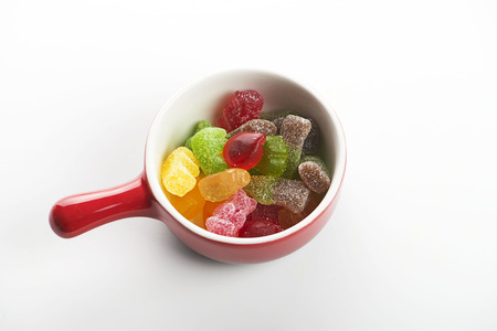 Container with sweets on white background.の写真素材