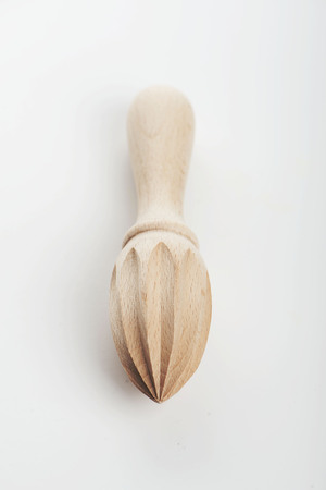 Small wooden manual squeezer for oranges and lemons from above.の写真素材