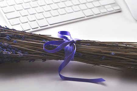 Lavender flower beside computer keyboard. Decor.の写真素材