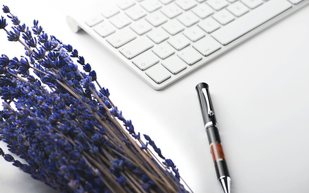 Computer keyboard ballpoint pen and lavender flower on white background. Technology and decoration.の写真素材