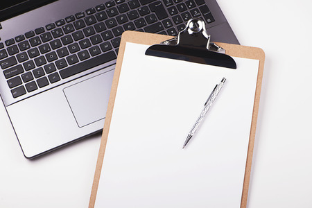 Folder with sheets on laptop keyboard. Horizontal shoot.の写真素材