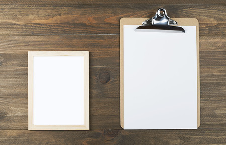Photo frame next to a folder with sheets of paper.