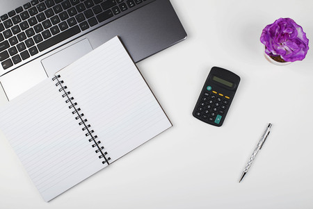 Notebook, laptop and calculator on office desk.の写真素材
