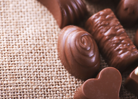 Horizontal close-up shot of chocolates and sweets placed on the canvas.の写真素材