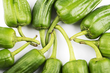 Various green peppers on white background. Healthy food.